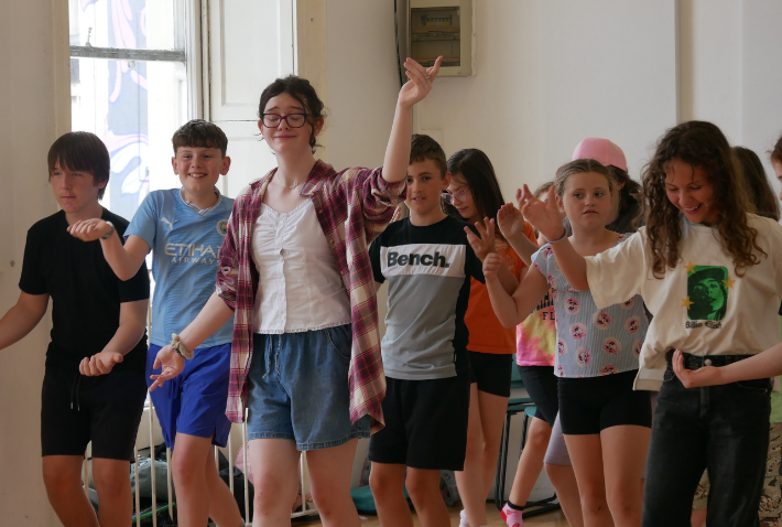 Children participating in a group drama and movement activity at Little Red Kettle’s summer camp.