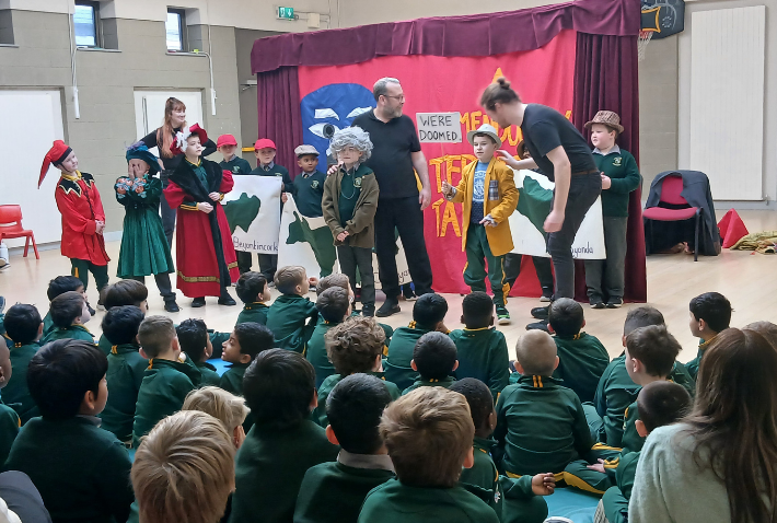 Children watching and taking part in Little Red Kettle’s Interactive Touring Play during a school performance.